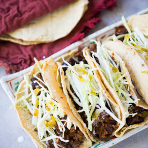 Vegan Mexican tacos recipe with corn tortillas and black beans with chorizo.