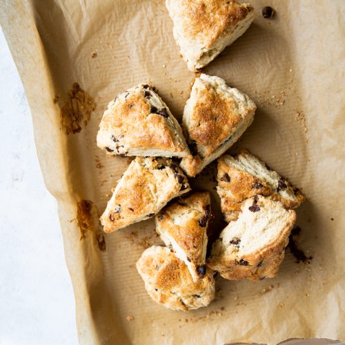 Scones de chocolate en una bandeja para hornear sobre una mesa.