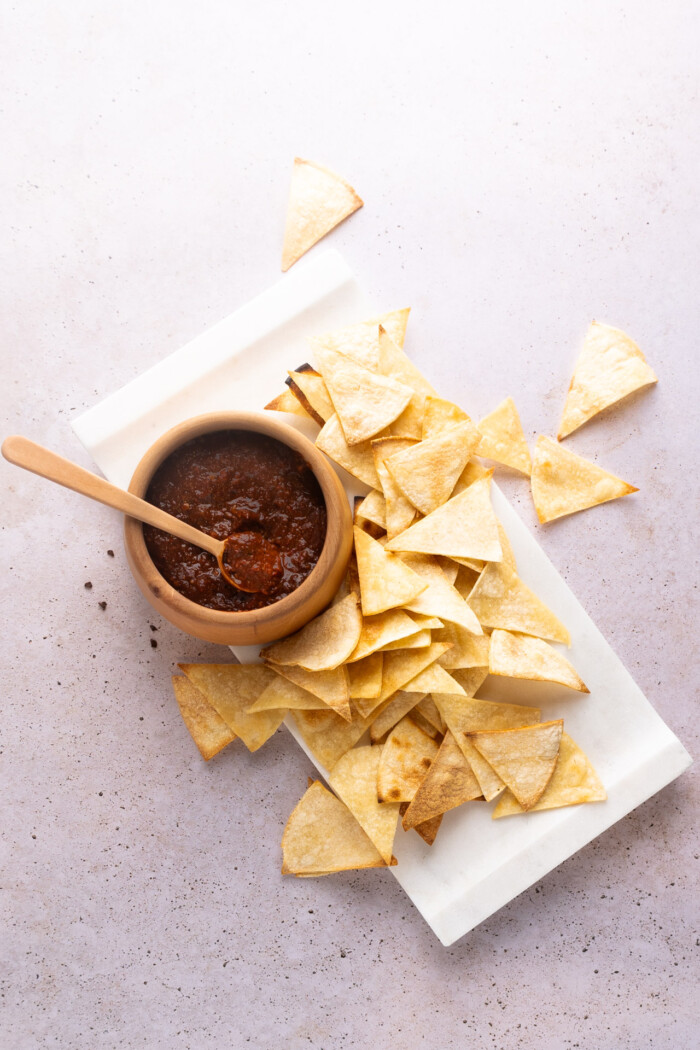 salsa tlaquepaque, en un salsero de madera con totops de maiz alrededor.