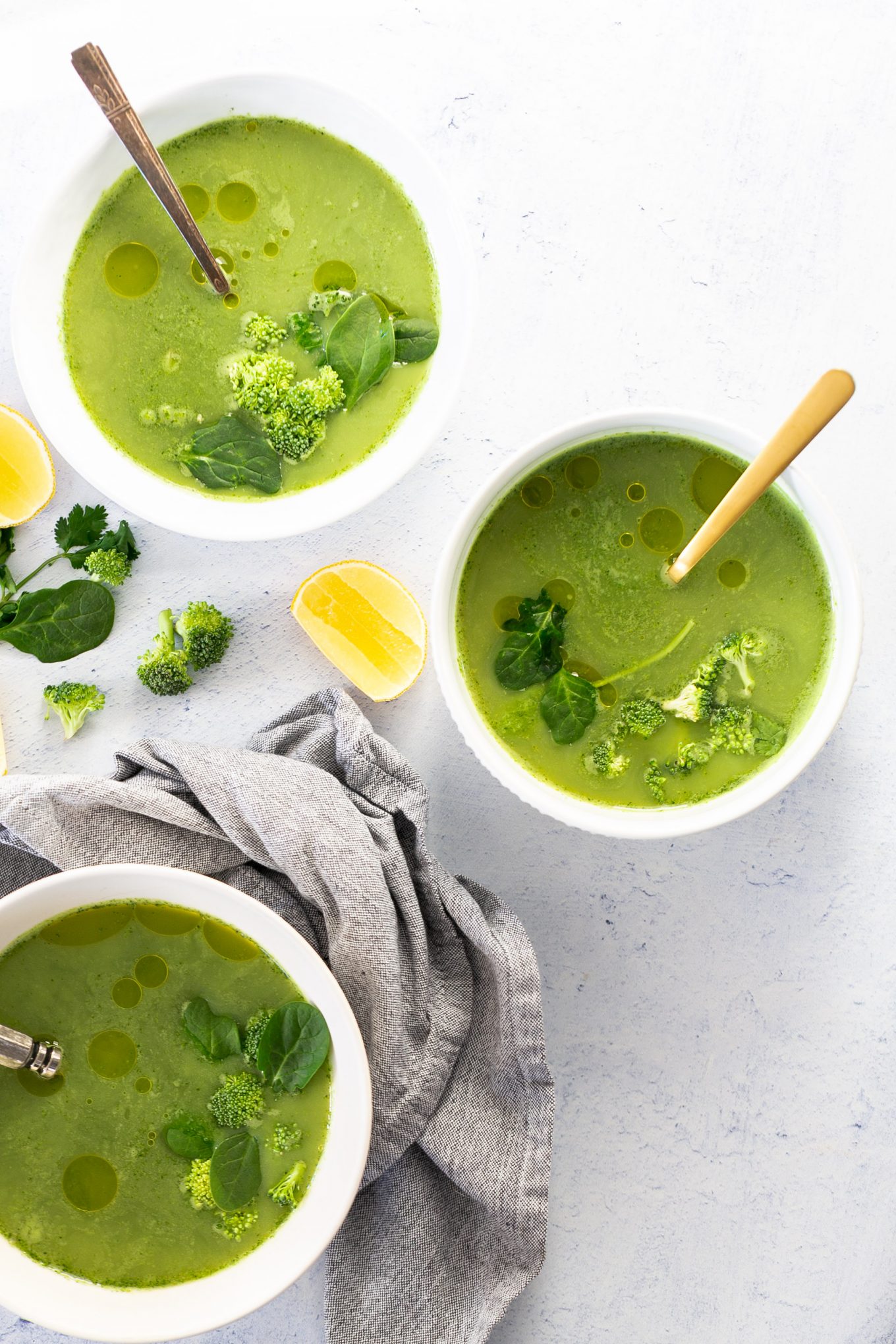 Three bowls of broccoli soup.